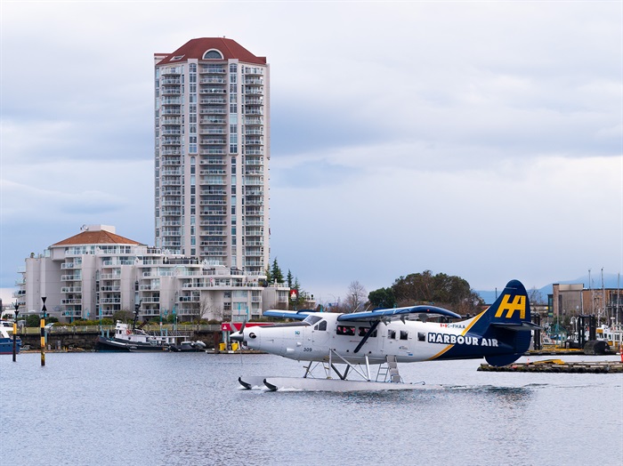 A Harbour Air seaplane is moving out to the open water for takeoff