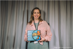 Jaime-Brett Sine, Culture Coordinator, accepting the award on the City's behalf