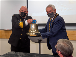Mayor Leonard Krog accepts HMCS Nanaimo's bell from Commander Jason Bergen