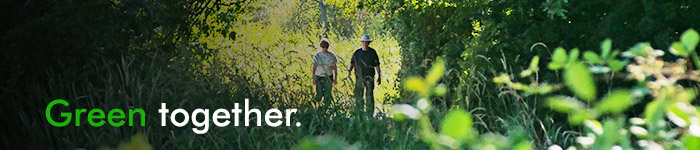 2 people walking through Buttertubs Marsh - green together