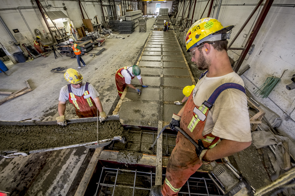 Photo of a construction team pouring concrete