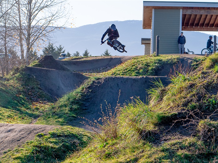 Bike Park photo Cyclist jumping on a downhill run at the Steve Smith Bike Park