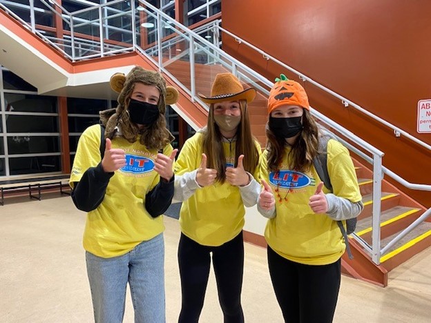 Three Leaders in Training in the Nanaimo Ice Centre Lobby giving the Thumbs Up signal