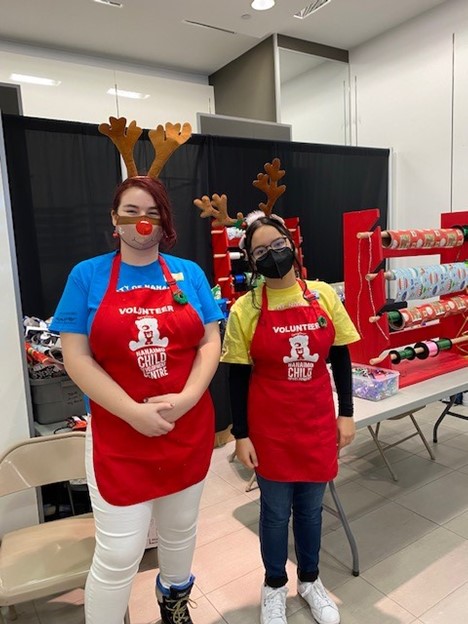 Youth leaders at a holiday wrapping station