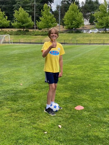 Leader in training at the soccer field with a soccer ball