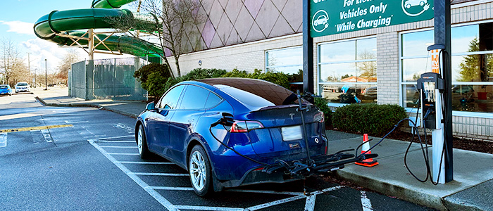 A blue Tesla charges at an EV station beside Beban Pool in Nanaimo