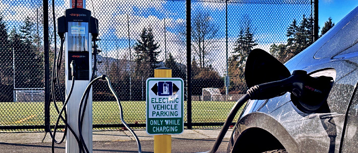 A close-up picture of an EV charger plugged into a vehicle at Merle Logan Park in Nanaimo.