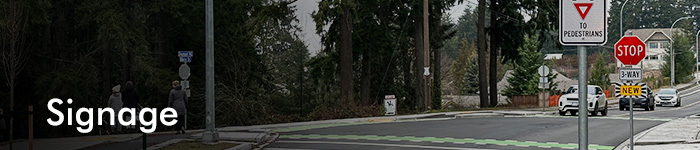 a banner image of a roadway with signs, titled Signage
