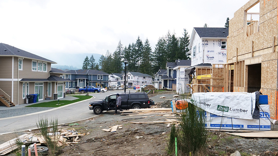 A photo looking down a new street with both completed homes and homes under construction