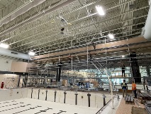 Deeppooltankwithoutwaterandscaffoldingerecteduptotheceilingjustbeyond