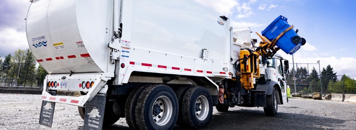 Recycling truck picking up a blue cart